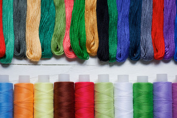 Close - up of coils of threads of different colors and shades for sewing, embroidery and creativity.