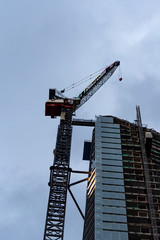 Construction Crane in a building, cloudy sky