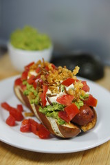 Hotdog topped with fried mealworms