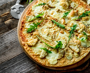 Pizza four cheeses on the table