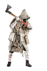 Post apocalypse world survivor, bandit or marauder in gas mask, ghillie cape, ragged clothes with runes, showing beckoning sign while standing with carpenters axe in hand, isolated on white shoot
