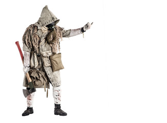 Post apocalypse world survivor, bandit or marauder in gas mask, ghillie cape, ragged clothes with runes, showing beckoning sign while standing with carpenters axe in hand, isolated on white shoot