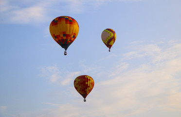 Fototapeta premium colorful hot air balloon against blue sky. hot air balloon is flying in white clouds. beautiful flying on hot air balloon