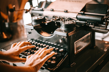 Old Typewriter antique or vintage Concept . Hands writing on old typewriter.