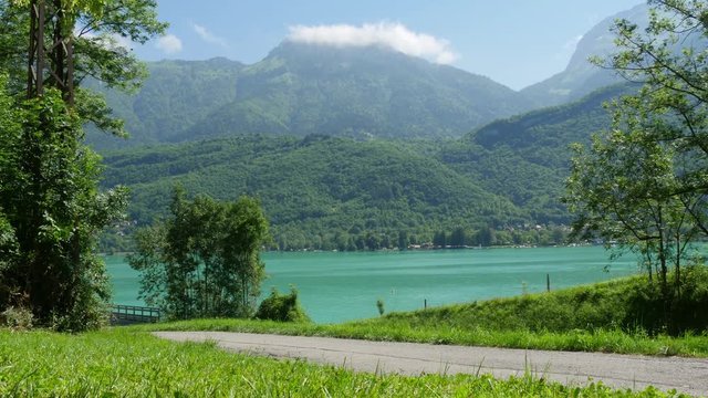 woman cycling on the bike path of Annecy Lake