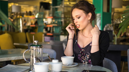 woman drinking coffee in the morning at restaurant, soft focus on the eyes