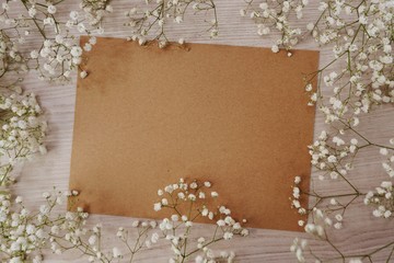 paper craft and dried flowers on wooden background