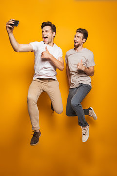 Full Length Portrait Of A Two Happy Young Men Best Friends