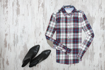 Checkered shirt and black shoes. Fashionable concept
