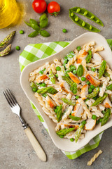 Italian pasta fusilli. Salad with chicken and asparagus in Béchamel sauce.