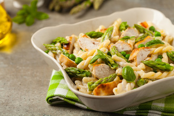 Italian pasta fusilli. Salad with chicken and asparagus in Béchamel sauce.