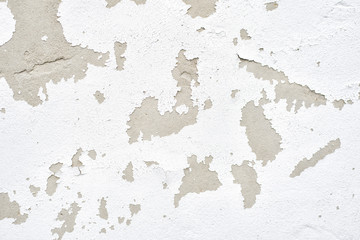 Wall with white peeling plaster. Close up