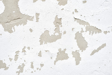 Wall with white peeling plaster. Close up