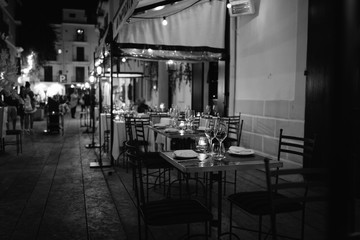 Glasses on the table in black and white in outdoor restaurant