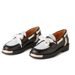 Elegant black and white loafers shoes with golden details. Studio shot, white background