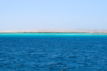 Obraz premium Mahmya island at Red Sea in Egypt, idyllic beach of Mahmya island with some boats in turquoise water, Egypt