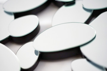 Mirror with ellipse, oval in wall, decoration and reflection. Abstract glass background. Polygonal surface. Close-up. Texture.