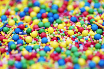 Fototapeta na wymiar Colourful candy cake decorative sprinkles background