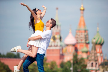 Young dating couple in love walking in city background St Basils Church