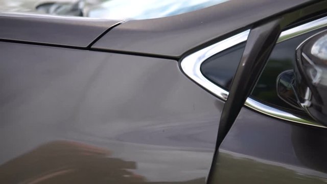 Modern car exterior, dolly shot of the car's headlamp.