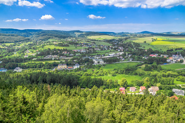 Fototapeta premium Aerial view of countryside landscape in mountain valley, town and houses in nature