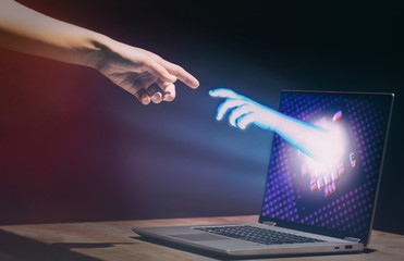Hands of artificial intelligence and human are touching. Virtual reality or artificial intelligence...