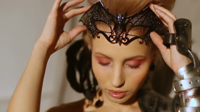 Close-up portrait of beautiful girl with a fantasy look. Woman in armor fantasy image for Halloween. Beautiful vampire lady gothic look