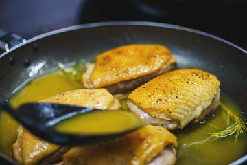 Process of making turkey breast in a frying pan with orange sauce. 