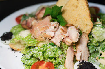 Caesar salad plate top on black background