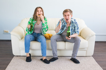 Friendship, sports, entertainment and soccer world cup - happy friends with chips and beer watching sports at home