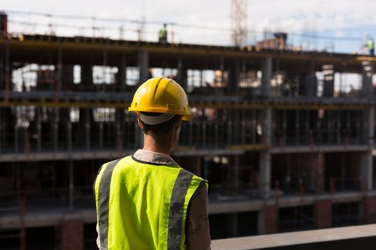 Female architect standing at construction site