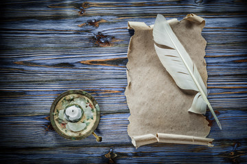 Vintage paper scroll quill candlestick on blue wooden background