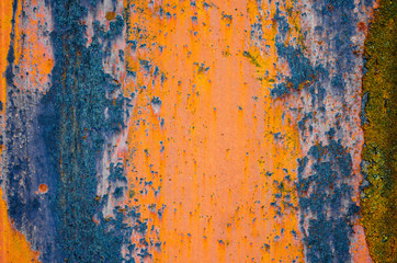 Rusty metal surface, orange and blue color of iron oxide