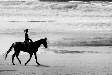 Horseback riding on Cannon beach, Oregon coast, USA