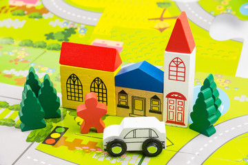 Naklejka premium Road traffic with wooden toy cars in the town on white background, safety and traffic regulations concept, backgrounds.Transportation system concept.
