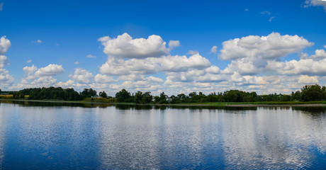 Reflection of clouds in the lake. Clouds over the lake. Lake for fishing and recreation outside the city