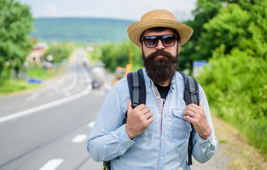 Look for fellow travelers. Tips of experienced backpacker. Man bearded hipster backpacker at edge of highway. Pick me up. Backpacker waiting for car take him anyway just to drop at better spot