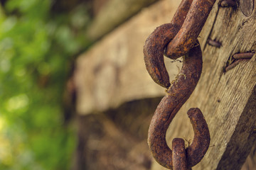 Old Chain Hanging on Wood