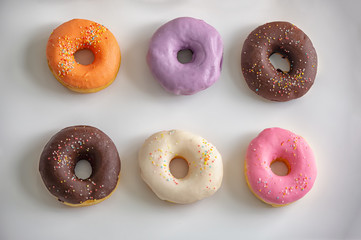 Set of colorful donuts isolated on white background. Top View Doughnuts collection into glaze for menu design, cafe decoration, delivery box in flat style