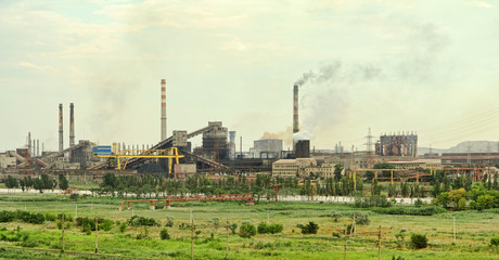 Fototapeta na wymiar Panoramic view of the large industrial plant with smoking factory chimneys.