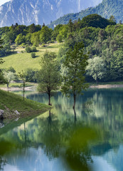fantastic view with reflections on the lake of tenno close to lago di garda in italy,