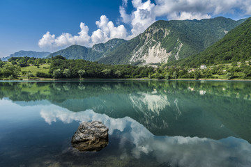 fantastic view with reflections on the lake of tenno close to lago di garda in italy,