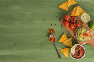 tortilla chips with dips, spices and vegetables
