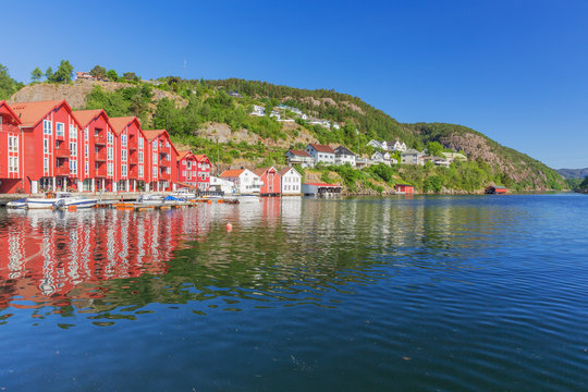 Typical Norwegian red vacation houses on the waterfront in Flekkefjord