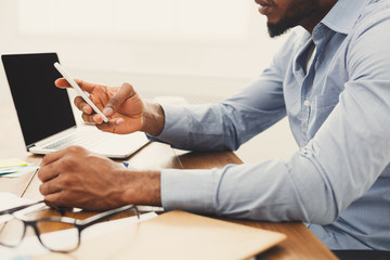 African-american businessman typing on laptop