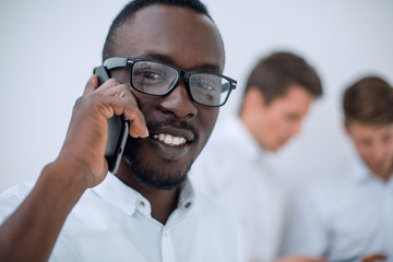 close up.successful businessman talking on mobile phone