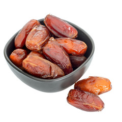 Bowl of dates isolated on white background - festive food.