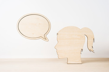 wooden girl silhouette head with dialogue frame