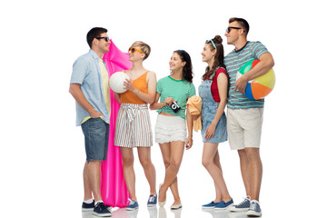 Obraz premium summer holidays and people concept - group of happy smiling friends in sunglasses with beach ball, volleyball, towel, camera and air mattress over white background
