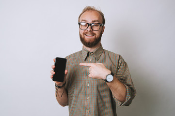 Cheerful man pointing at phone